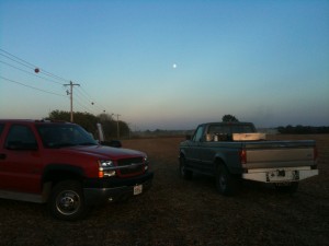 Notice the Moon in the sky. Early evening harvesting soybeans.