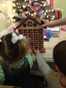 Children Take Turns Opening Advent Calendar