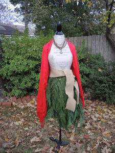 The Mannequin Evergreen Tree Skirt really gets noticed with a red scarf.