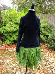 The Mannequin Evergreen Tree Skirt looks elegant in a black velvet top 