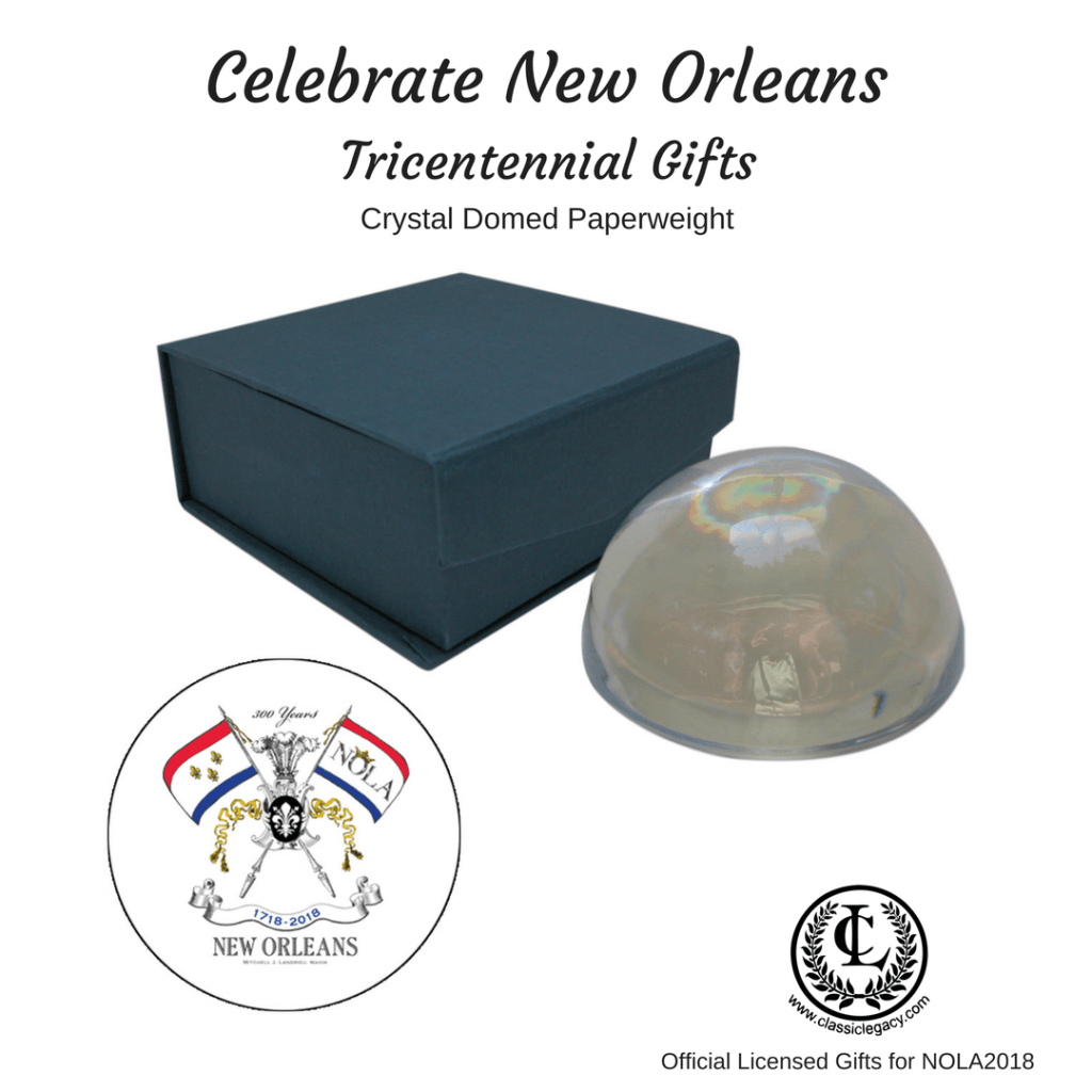 New Orleans Tricentennial gifts include this crystal domed paperweight with the NOLA2018 logo