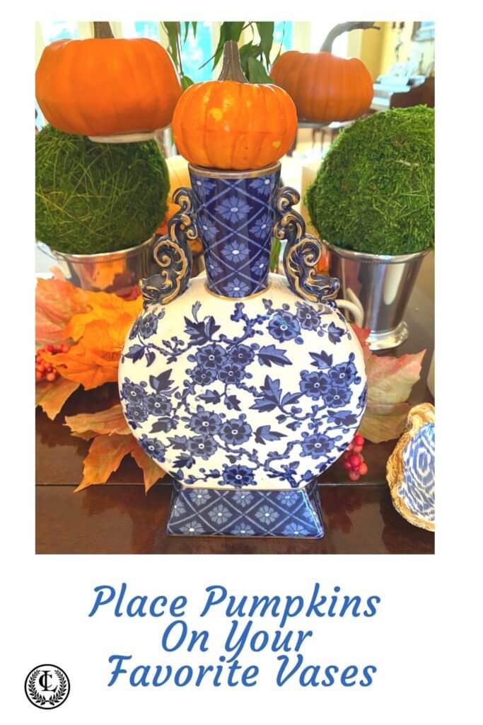 Place little pumpkins all around including on top of vases to create a festive Thanksgiving decor with blue and white accents.
