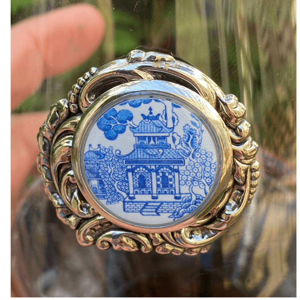 Close view of the Classic Legacy blue Chinoiserie medallion setting against the silver medallion.