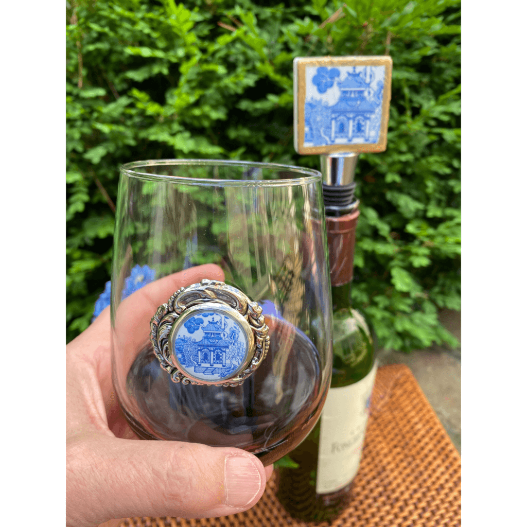 Holding the stemless wine glass with blue and wine Chinoiserie medallion.
