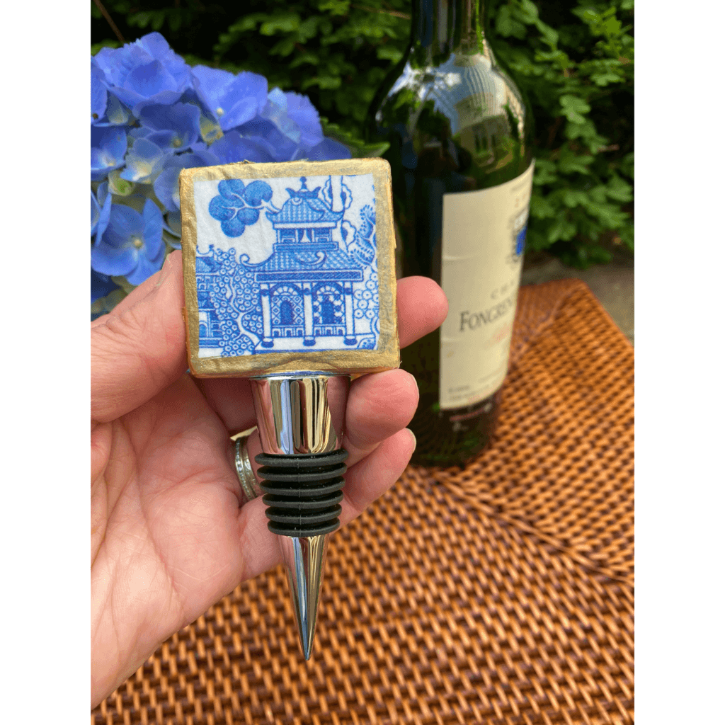 Holding the Classic Legacy  blue and white Chinoiserie wine bottle stopper.