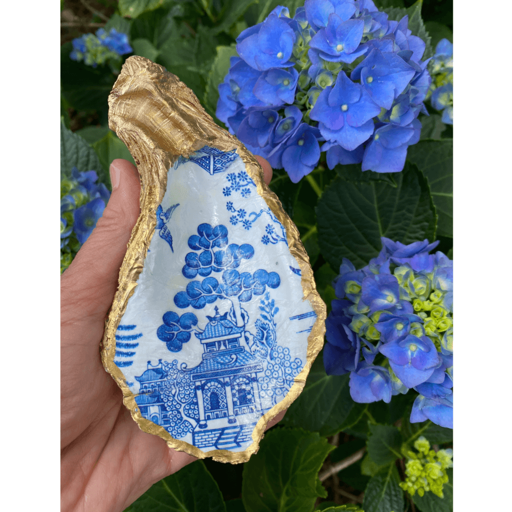 Holding the blue and white Chinoiserie oyster shell dish.